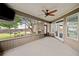 Relaxing screened porch featuring a ceiling fan, offering a serene outdoor retreat at 214 Harmony Lake Dr, Canton, GA 30115