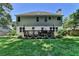Expansive backyard featuring a wooden deck, complemented by lush landscaping and verdant lawn at 2625 Harbor Point Ct, Cumming, GA 30041