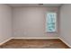 Bedroom boasts natural light with hardwood floors at 2625 Harbor Point Ct, Cumming, GA 30041