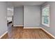 Bedroom with hardwood floors, light blue walls, one window and an open doorway at 2625 Harbor Point Ct, Cumming, GA 30041