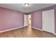 Bedroom with hardwood floors, light purple walls, and an ensuite bathroom at 2625 Harbor Point Ct, Cumming, GA 30041