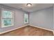 Bedroom features two windows that provide natural light and hardwood floors at 2625 Harbor Point Ct, Cumming, GA 30041