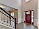 Bright foyer with a two-story ceiling, hardwood floors, and a striking red front door with sidelights at 2625 Harbor Point Ct, Cumming, GA 30041