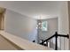 Bright hallway featuring a modern chandelier and staircase with black and white trim at 2625 Harbor Point Ct, Cumming, GA 30041