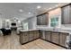 Bright kitchen with stainless steel appliances, granite countertops, and a view into the living room at 2625 Harbor Point Ct, Cumming, GA 30041