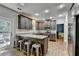 Well-lit kitchen with stainless steel appliances, granite countertops, and a breakfast bar with seating at 2625 Harbor Point Ct, Cumming, GA 30041