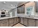 Well-equipped kitchen featuring stainless steel appliances, granite countertops, and light-colored wood flooring at 2625 Harbor Point Ct, Cumming, GA 30041