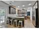 Open concept kitchen with gray cabinets, a center island with bar stool seating, and stainless-steel appliances at 2625 Harbor Point Ct, Cumming, GA 30041