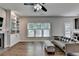 Living room featuring fireplace, built-in shelving, and lots of natural light with a view of the kitchen area at 2625 Harbor Point Ct, Cumming, GA 30041