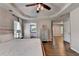 Spacious main bedroom with hardwood floors, tray ceiling, and access to bathroom at 2625 Harbor Point Ct, Cumming, GA 30041