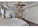 Spacious main bedroom with hardwood floors, tray ceiling, and access to bathroom at 2625 Harbor Point Ct, Cumming, GA 30041