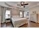 Relaxing main bedroom with tray ceiling, ceiling fan, and wood-look floors at 2625 Harbor Point Ct, Cumming, GA 30041