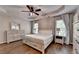 Relaxing main bedroom with tray ceiling, ceiling fan, and wood-look floors at 2625 Harbor Point Ct, Cumming, GA 30041