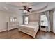 Relaxing main bedroom with tray ceiling, ceiling fan, and wood-look floors at 2625 Harbor Point Ct, Cumming, GA 30041