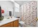 Well-lit bathroom featuring a floral shower curtain and a single-sink vanity at 3309 Raes Creek Rd # 13, Marietta, GA 30008
