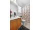 Well-lit bathroom featuring a floral shower curtain, single sink vanity, and gray rug at 3309 Raes Creek Rd # 13, Marietta, GA 30008