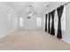 Bright bedroom with a ceiling fan, tv mount, and multiple windows dressed with black patterned curtains at 3309 Raes Creek Rd # 13, Marietta, GA 30008