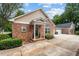 Inviting brick home featuring a charming front porch and attached two-car garage at 3309 Raes Creek Rd # 13, Marietta, GA 30008