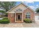 Brick home featuring a charming front porch and well-maintained landscaping at 3309 Raes Creek Rd # 13, Marietta, GA 30008