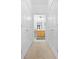 Hallway with white doors and gold handles, leading to a bright kitchen at 3309 Raes Creek Rd # 13, Marietta, GA 30008
