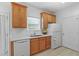 Well-lit kitchen with light wood cabinets, white appliances, a stainless steel sink, and quartz countertops at 3309 Raes Creek Rd # 13, Marietta, GA 30008