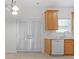 Kitchen with white countertops, wood cabinets, double doors and stainless steel dishwasher at 3309 Raes Creek Rd # 13, Marietta, GA 30008