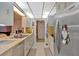 Galley kitchen with white cabinets and stainless steel appliances at 4866 S Lilburn Stone Mountain Road Sw, Lilburn, GA 30047