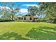 Spacious backyard with lush greenery, showcasing the home's exterior, back deck, and a convenient storage shed at 4866 S Lilburn Stone Mountain Road Sw Rd, Lilburn, GA 30047