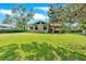 Lush backyard featuring a well-maintained lawn, back deck, and the home's exterior, perfect for outdoor activities at 4866 S Lilburn Stone Mountain Road Sw Rd, Lilburn, GA 30047