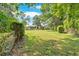 Expansive backyard featuring lush green grass, mature trees, fenced perimeter offering privacy and space at 4866 S Lilburn Stone Mountain Road Sw Rd, Lilburn, GA 30047