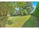Expansive backyard with lush greenery, highlighting the home's exterior and a functional storage shed at 4866 S Lilburn Stone Mountain Road Sw Rd, Lilburn, GA 30047