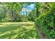 Spacious backyard with lush green grass and mature trees, creating a serene outdoor oasis for relaxation at 4866 S Lilburn Stone Mountain Road Sw Rd, Lilburn, GA 30047