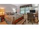 Bedroom with a queen-sized bed, desk, and a large window at 4866 S Lilburn Stone Mountain Road Sw Rd, Lilburn, GA 30047