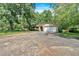 Charming single-story home with mature trees, lush lawn, two-car garage, and a brick and siding exterior at 4866 S Lilburn Stone Mountain Road Sw Rd, Lilburn, GA 30047