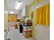 Hallway with utility closet, storage and doorway to outside, bright yellow and white striped wallpaper at 4866 S Lilburn Stone Mountain Road Sw Rd, Lilburn, GA 30047