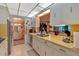 Galley kitchen with stainless steel appliances and ample counter space, leading to the dining room at 4866 S Lilburn Stone Mountain Road Sw Rd, Lilburn, GA 30047
