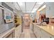 Galley kitchen features stainless steel appliances and ample counter space, plus an attached eat-in area at 4866 S Lilburn Stone Mountain Road Sw Rd, Lilburn, GA 30047