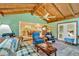 Open floor plan features a combined living room with vaulted wood ceilings and backyard views at 4866 S Lilburn Stone Mountain Road Sw Rd, Lilburn, GA 30047
