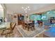 Open-concept living and dining area with tile floors, wood beams, and plentiful natural light at 4866 S Lilburn Stone Mountain Road Sw Rd, Lilburn, GA 30047