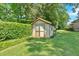 Cozy shed nestled in a well-maintained backyard with lush greenery, perfect for storage or a workshop at 4866 S Lilburn Stone Mountain Road Sw Rd, Lilburn, GA 30047