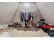 Finished attic space with a vaulted ceiling and clothing rack for extra storage at 6492 Swift Creek Road, Lithonia, GA 30058