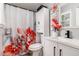 Cozy bathroom featuring a shower with a floral curtain and modern vanity at 6492 Swift Creek Road, Lithonia, GA 30058