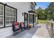 Side view of a deck with outdoor seating and black trim at 6492 Swift Creek Road, Lithonia, GA 30058
