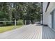 View of a spacious outdoor deck with metal cable railing overlooking a green backyard at 6492 Swift Creek Road, Lithonia, GA 30058