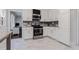Well-lit kitchen featuring stainless steel appliances, granite counters, and bright white cabinets at 6492 Swift Creek Road, Lithonia, GA 30058