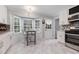 Bright eat-in kitchen featuring white cabinets, a bay window, and stainless steel appliances at 6492 Swift Creek Road, Lithonia, GA 30058