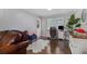 Spacious living room with hardwood floors, a desk area, and natural light at 6492 Swift Creek Road, Lithonia, GA 30058