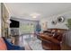 Bright living room with hardwood floors, a bay window, stone fireplace, and ample seating at 6492 Swift Creek Road, Lithonia, GA 30058