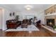 Open-concept living room featuring hardwood floors, a fireplace, and stylish decor at 6492 Swift Creek Road, Lithonia, GA 30058