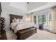 Spacious main bedroom with tray ceiling, large windows, and stylish decor at 6492 Swift Creek Road, Lithonia, GA 30058